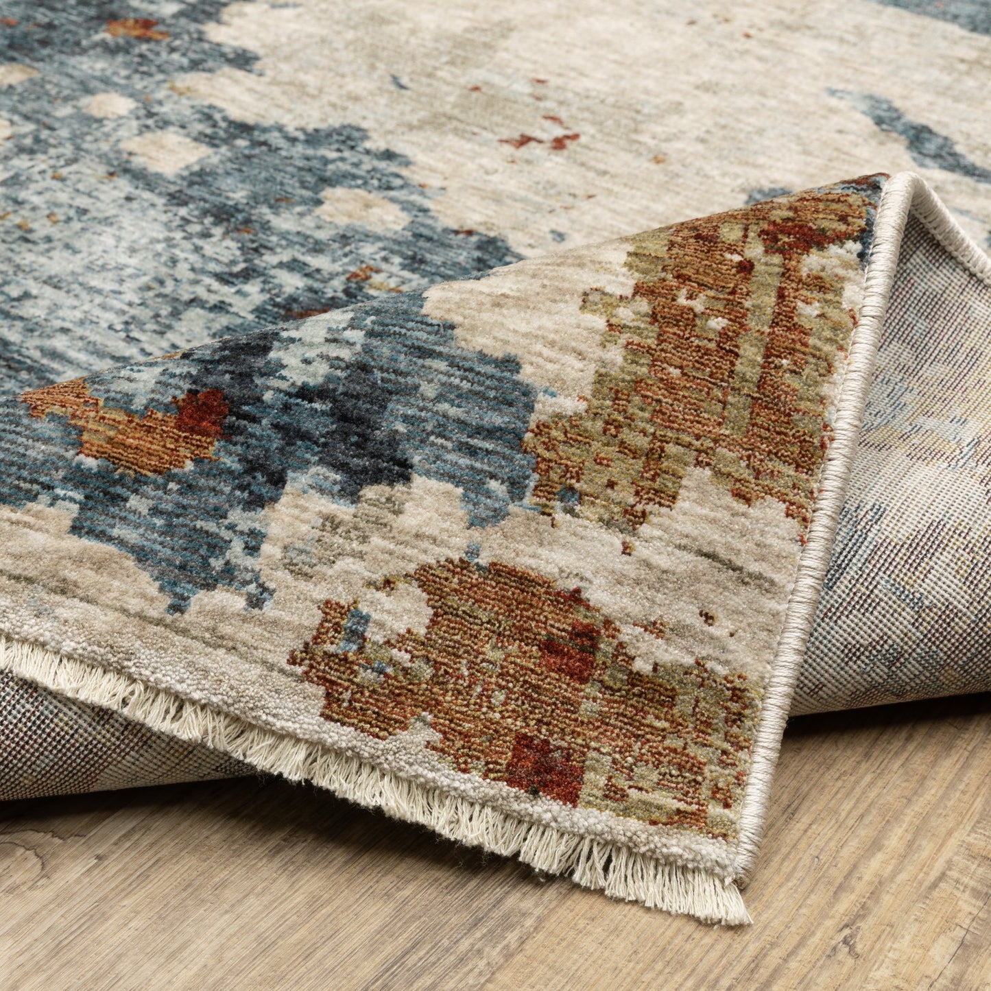 5' X 8' Beige Rust And Teal Abstract Distressed Area Rug With Fringe